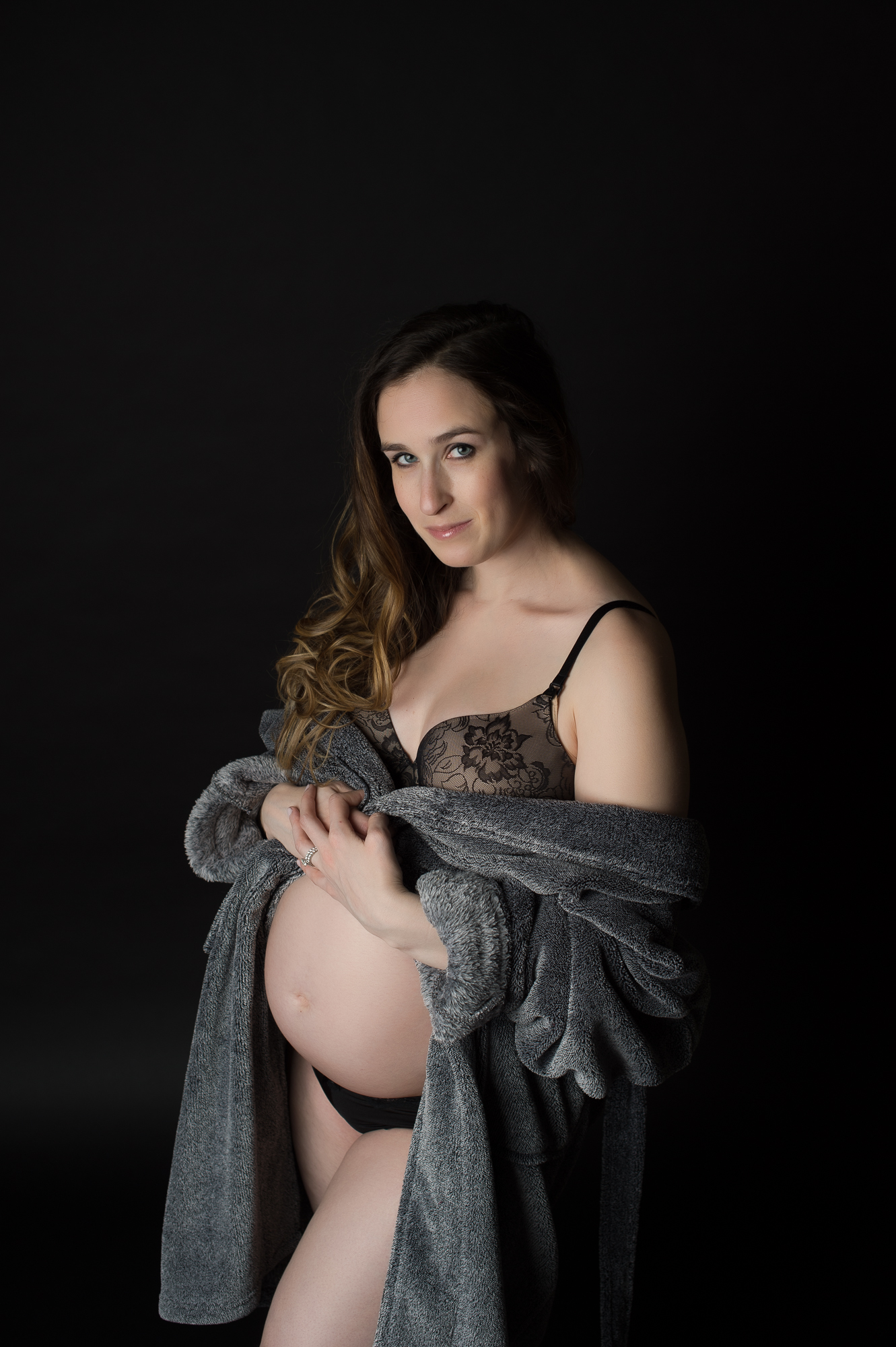 Maternity Portrait in Husbands bathrobe on black background